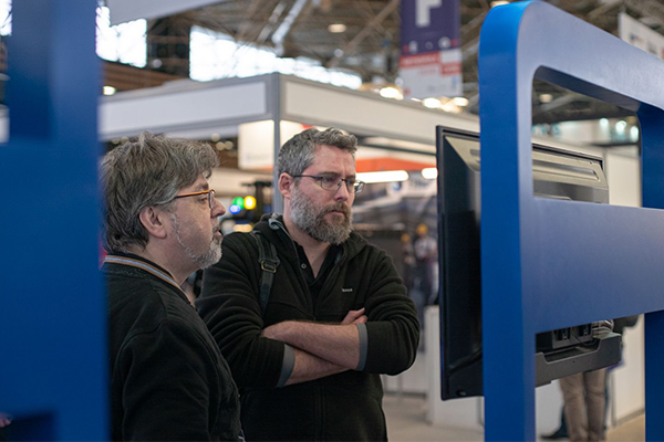 Visitors watched a demo at the booth.
